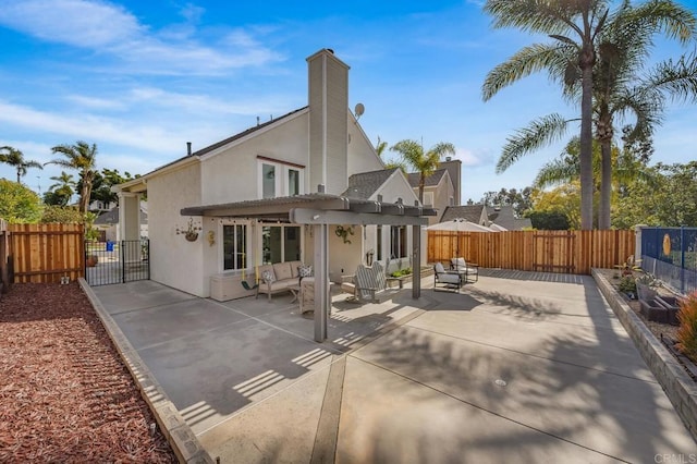 back of property featuring fence private yard, outdoor lounge area, and stucco siding