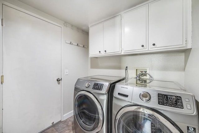 laundry room featuring cabinet space and washing machine and clothes dryer