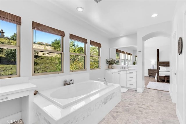 full bathroom featuring recessed lighting, ensuite bath, a bath, and vanity