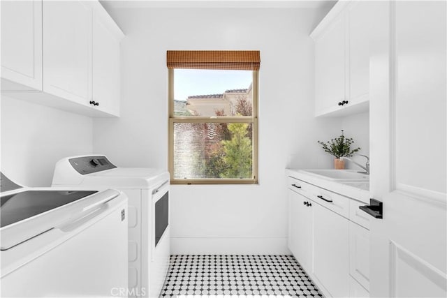 laundry room featuring independent washer and dryer, a sink, and cabinet space