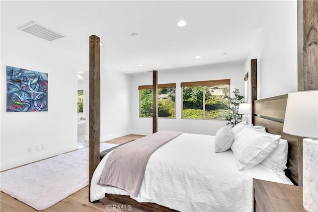 bedroom featuring baseboards, visible vents, wood finished floors, and recessed lighting