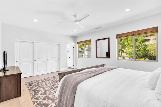 bedroom featuring a ceiling fan, recessed lighting, a closet, and light wood-style flooring