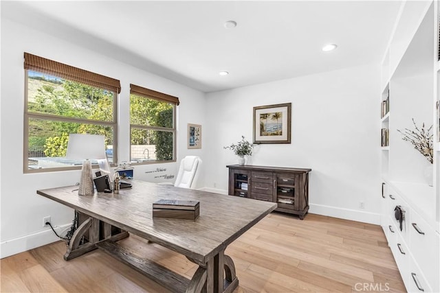 home office featuring light wood finished floors, recessed lighting, and baseboards