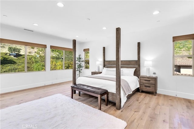 bedroom featuring light wood-type flooring, visible vents, and recessed lighting