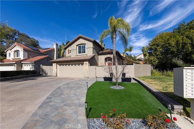 mediterranean / spanish-style home featuring a garage, a tiled roof, driveway, stucco siding, and a front yard