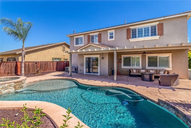 back of house with a fenced backyard, a patio, and stucco siding