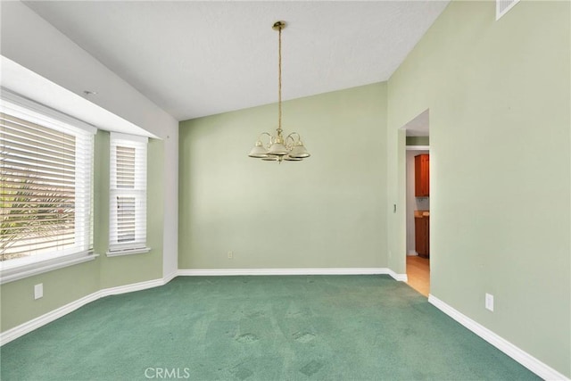 empty room featuring dark colored carpet, lofted ceiling, visible vents, a chandelier, and baseboards