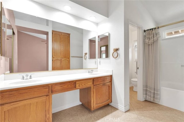 bathroom with a sink, toilet, and tile patterned floors