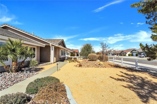 view of yard featuring a residential view and fence