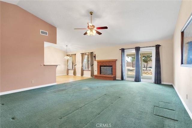 unfurnished living room featuring visible vents, baseboards, lofted ceiling, ceiling fan, and carpet