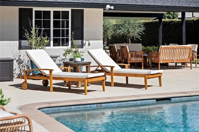 community pool featuring a patio area and outdoor lounge area