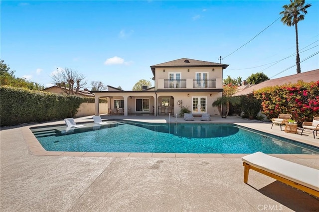 view of swimming pool with a fenced in pool, french doors, a patio, and fence