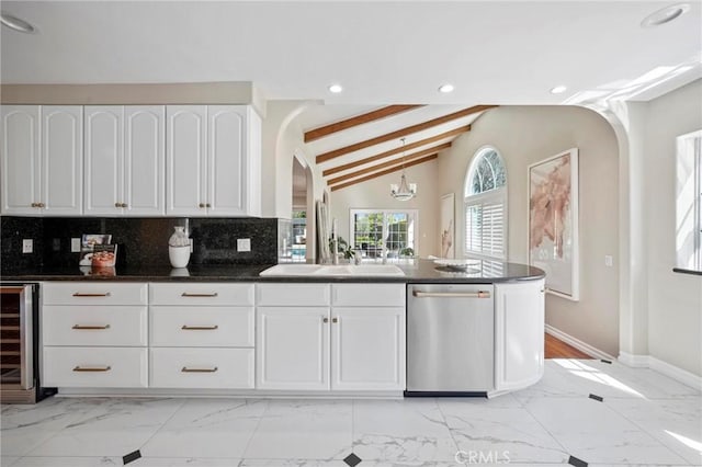 kitchen with dishwasher, marble finish floor, arched walkways, and wine cooler