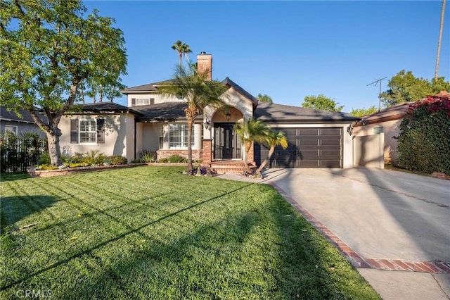 view of front of home with concrete driveway, a chimney, a front lawn, an attached garage, and stucco siding