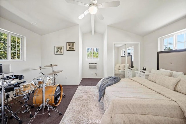 bedroom with vaulted ceiling, dark carpet, and multiple windows