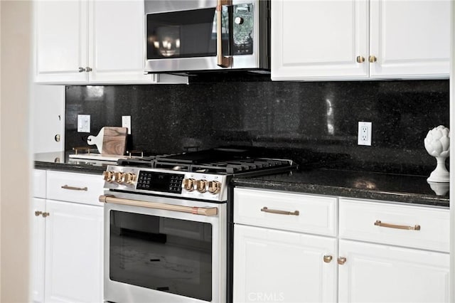 kitchen featuring decorative backsplash, appliances with stainless steel finishes, and white cabinets