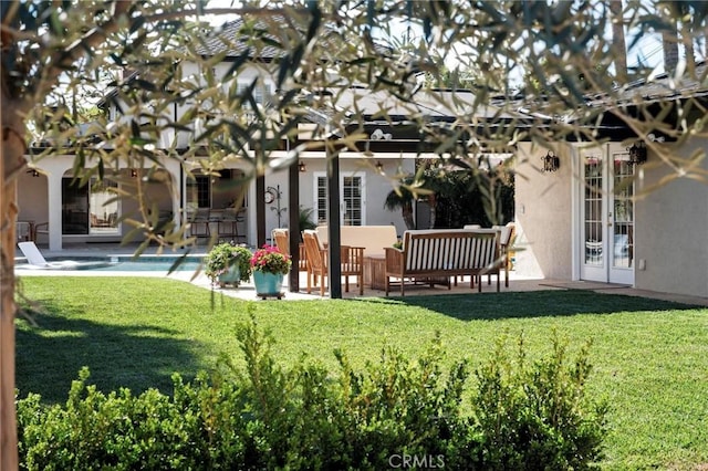view of yard featuring an outdoor pool, french doors, and a patio