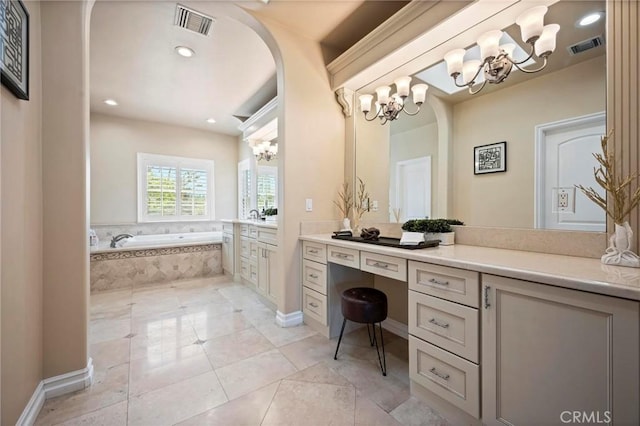 full bathroom featuring a bath, vanity, a chandelier, and visible vents