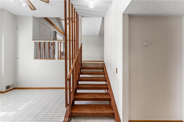 21013 Carriage Dr, Tehachapi, CA 93561 - staircase with a textured ceiling, visible vents, tile patterned flooring, and a ceiling fan