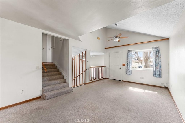 21013 Carriage Dr, Tehachapi, CA 93561 - carpeted foyer entrance featuring a ceiling fan, lofted ceiling, a textured ceiling, and baseboards