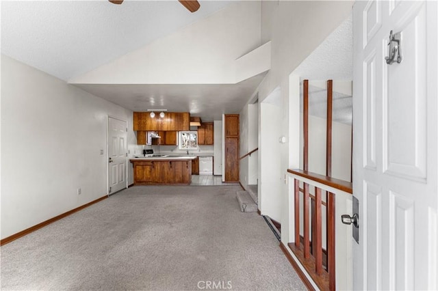 21013 Carriage Dr, Tehachapi, CA 93561 - unfurnished living room with lofted ceiling, ceiling fan, baseboards, and light colored carpet