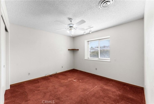 21013 Carriage Dr, Tehachapi, CA 93561 - spare room featuring carpet floors, visible vents, a textured ceiling, and a ceiling fan