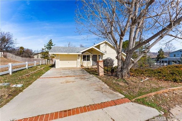 21013 Carriage Dr, Tehachapi, CA 93561 - view of front of house featuring fence, driveway, and an attached garage