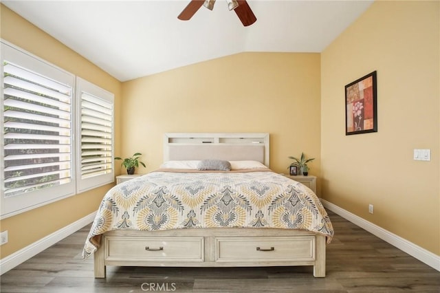 bedroom with vaulted ceiling, ceiling fan, wood finished floors, and baseboards