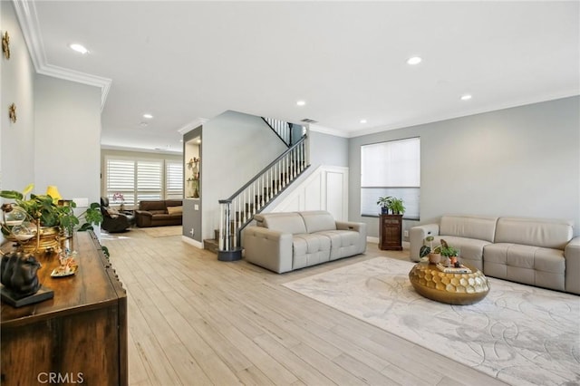 living area featuring baseboards, stairway, crown molding, light wood-type flooring, and recessed lighting