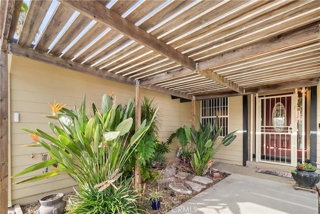 entrance to property with a pergola