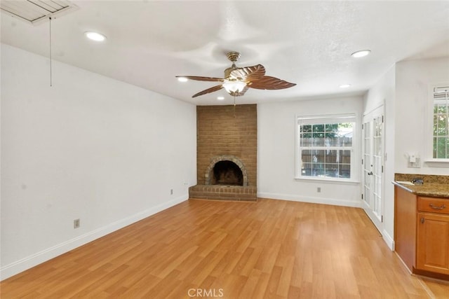 2655 Marseille Way, Stockton, CA 95209 - unfurnished living room featuring ceiling fan, light wood finished floors, plenty of natural light, a brick fireplace, and recessed lighting