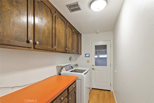 2655 Marseille Way, Stockton, CA 95209 - laundry area featuring light wood-type flooring, cabinet space, independent washer and dryer, and baseboards