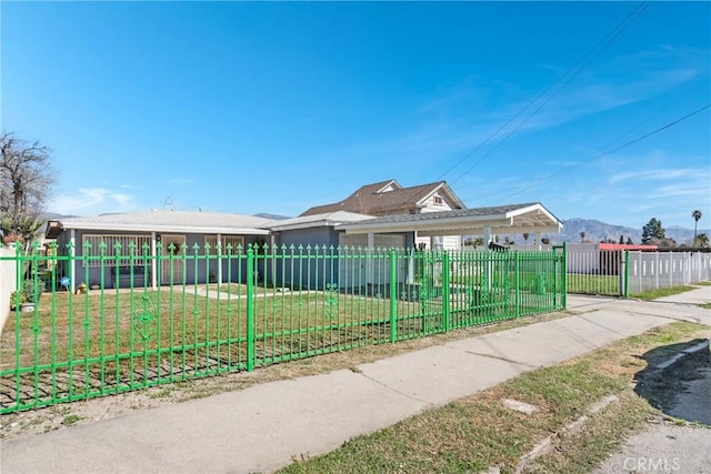 view of front facade with a fenced front yard and a front lawn