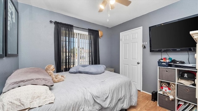 bedroom with ceiling fan and wood finished floors