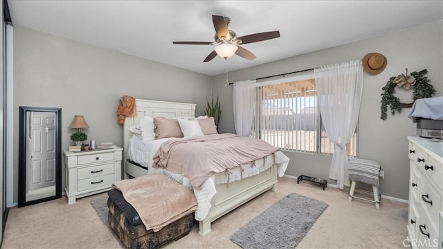 bedroom with baseboards, access to outside, a ceiling fan, and light colored carpet