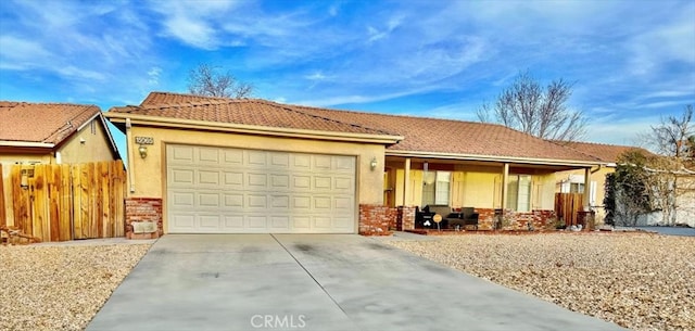 single story home featuring stucco siding, fence, a garage, driveway, and a tiled roof