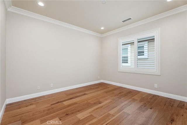 unfurnished room with baseboards, visible vents, light wood finished floors, recessed lighting, and crown molding