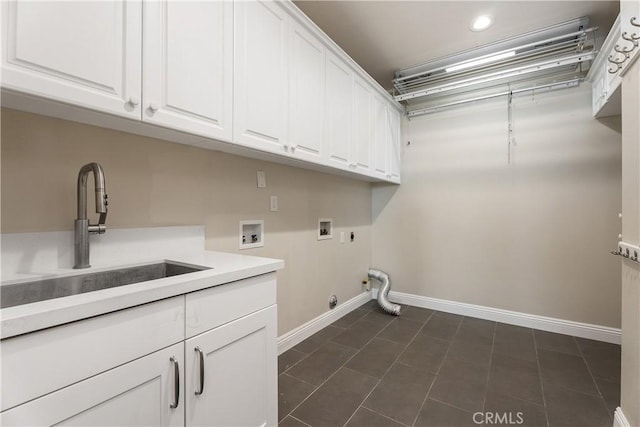 laundry room featuring gas dryer hookup, hookup for a washing machine, cabinet space, hookup for an electric dryer, and a sink