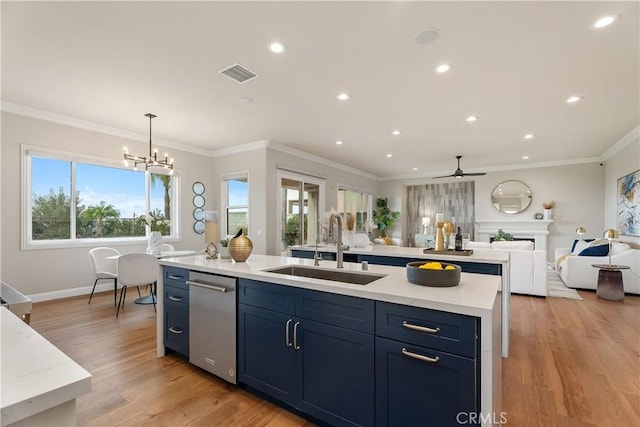 kitchen with open floor plan, light wood-style flooring, visible vents, and a sink