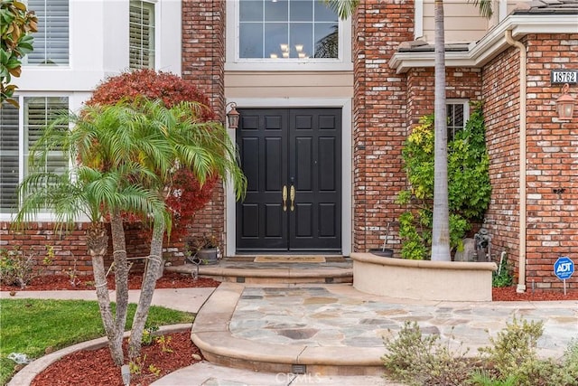 property entrance with brick siding