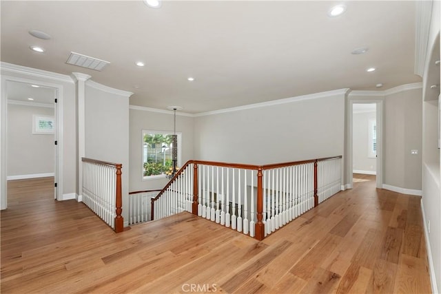 hall featuring an upstairs landing, visible vents, light wood-type flooring, and baseboards