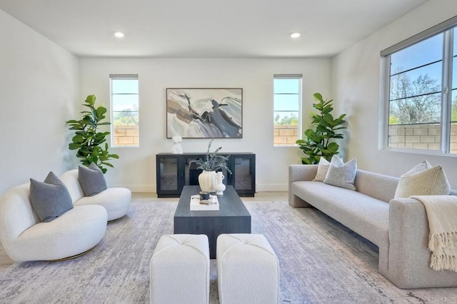 living area featuring recessed lighting, a wealth of natural light, and baseboards