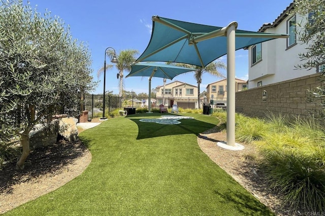 view of yard featuring a residential view and fence