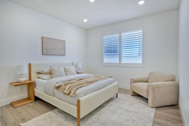 bedroom with baseboards, light wood-type flooring, and recessed lighting