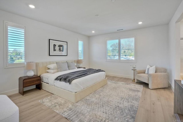 bedroom featuring light wood finished floors, recessed lighting, visible vents, and baseboards