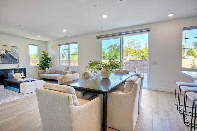 dining area with recessed lighting, baseboards, and light wood finished floors