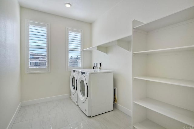 laundry room with laundry area, baseboards, and washing machine and clothes dryer