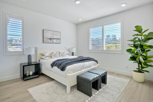 bedroom featuring light wood-style flooring, baseboards, and recessed lighting