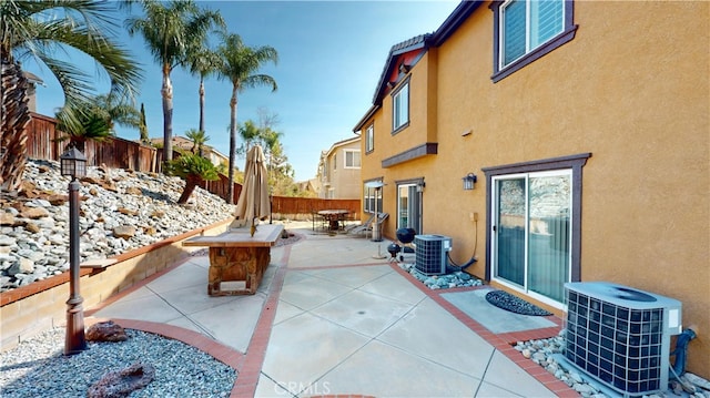 view of patio with a fenced backyard and central air condition unit