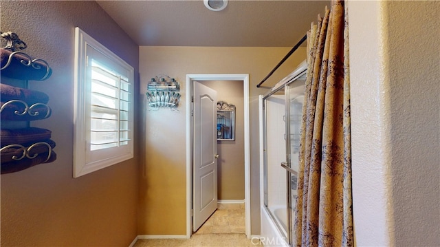 11318 Fitzpatrick Dr, Rancho Cucamonga, CA 91730 - corridor featuring a textured wall, baseboards, and light tile patterned flooring